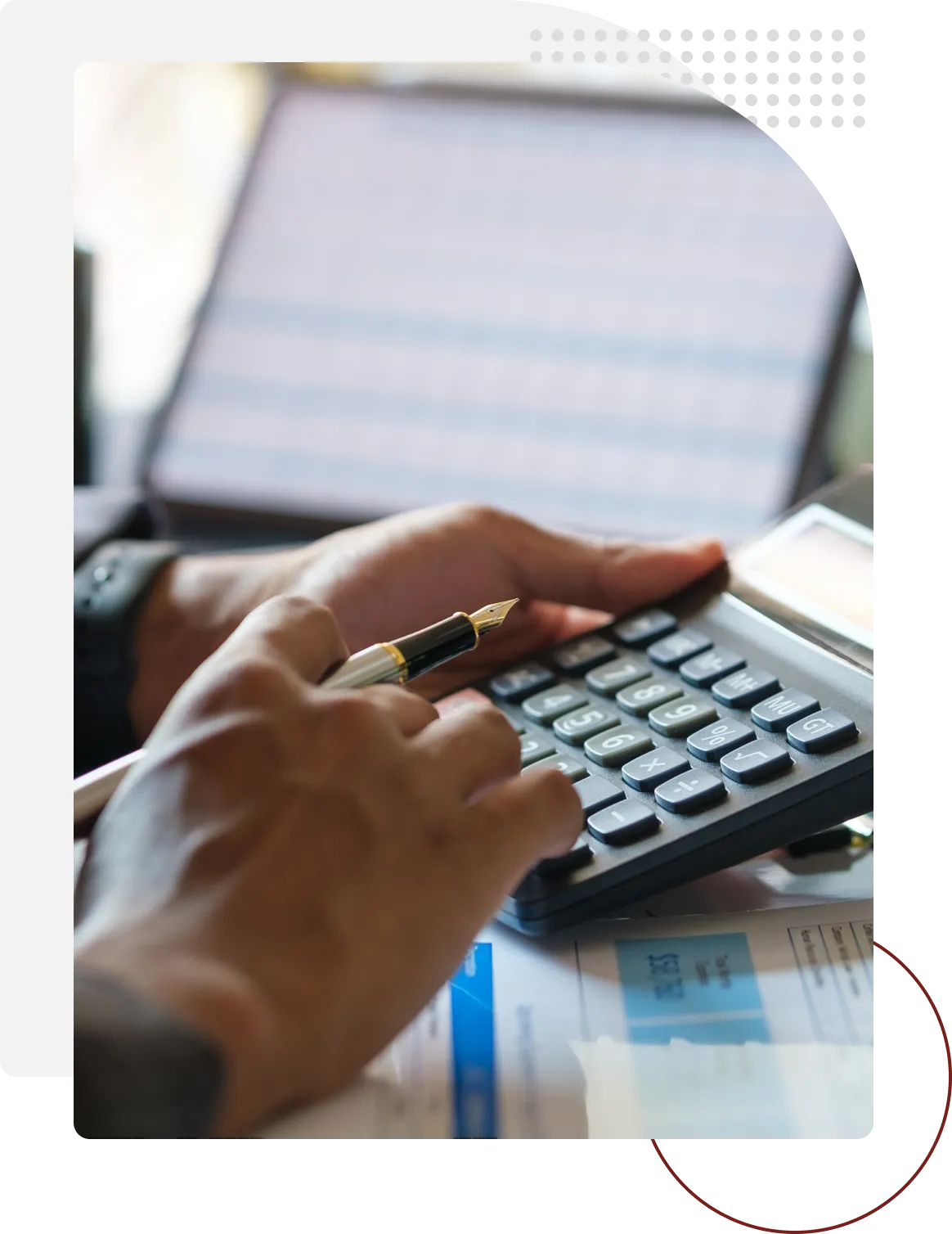 A person using a calculator on top of a table.